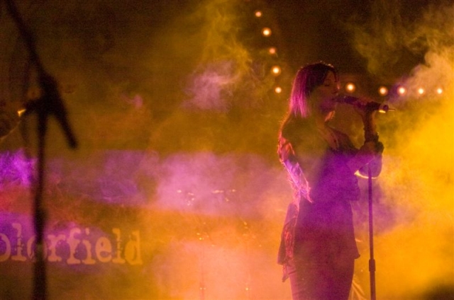Photo of Colorfield's lead singer totally backlit with yellow and purple.  John Schlick was the Lighting Designer.