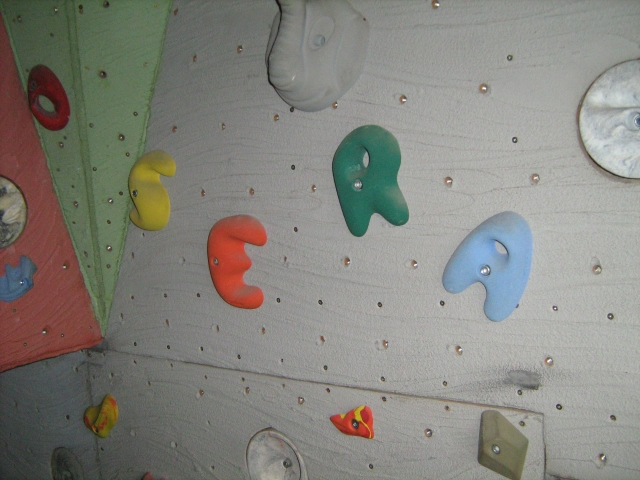 Picture of the Climbing wall in my house. Looking at where I put my daughters name in it.