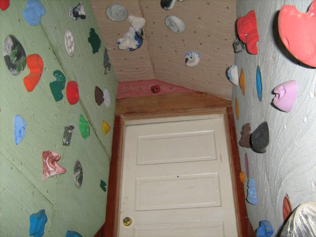Picture of the Climbing wall in my house. Looking up at the door at the top of the stairs.