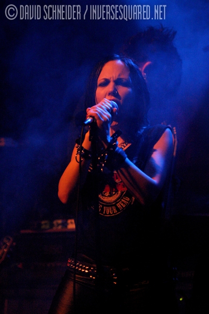 Photo of Betty X lit in red with a blue background taken at Studio Seven when John Schlick was the Lighting Designer.