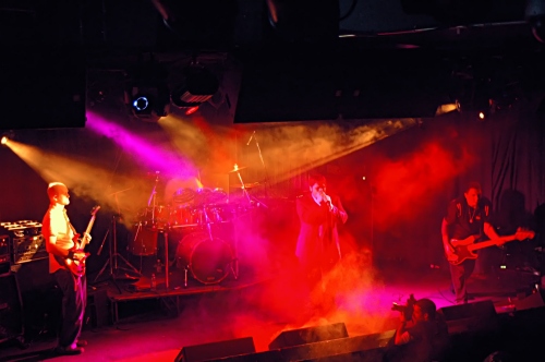 Orange, pink and red beamy shot of Counterfist.  John Schlick was the Lighting Designer for this show.