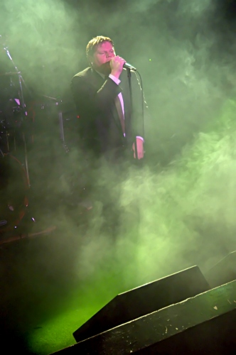 Shot of George of Counterfist framed in misty green.  John Schlick was the Lighting Designer for this show.