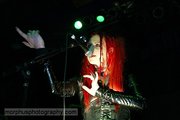 Photo of Vas of Hanzel Und Gretyl with her hands uplit taken at the Masquerade in Tampa that John Schlick was Lighting Designer for.