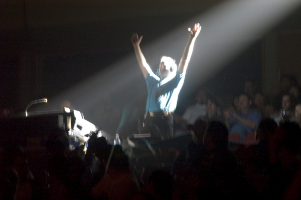 Photo of John Schlick the Concert Lighting Designer focusing lights at a show.